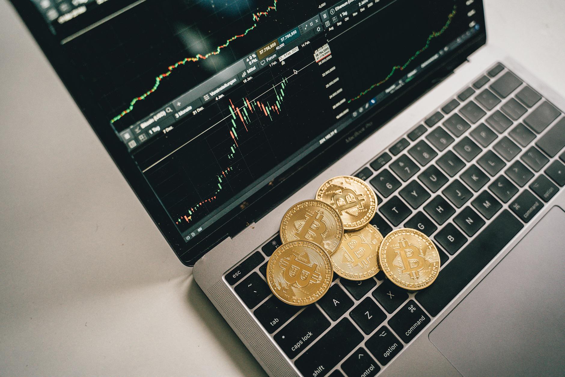 coins on top of a laptop